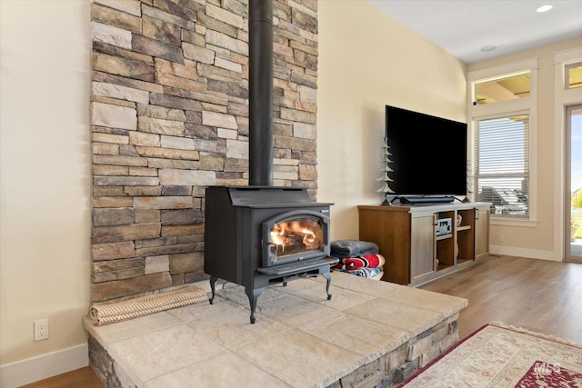550 W Heikes Ln, Eagle, ID 83616 - living area with a wood stove, wood finished floors, baseboards, and recessed lighting