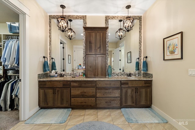 550 W Heikes Ln, Eagle, ID 83616 - full bath featuring a chandelier, double vanity, tile patterned flooring, and baseboards