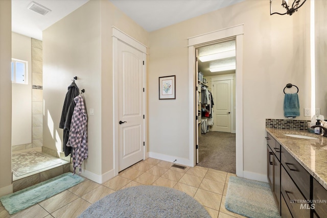 550 W Heikes Ln, Eagle, ID 83616 - full bathroom with vanity, tile patterned floors, baseboards, and backsplash