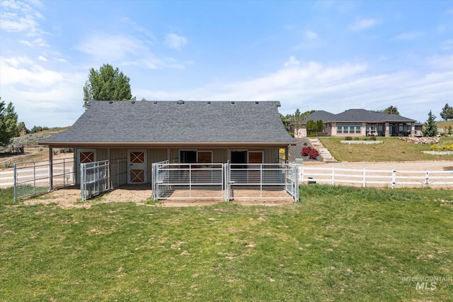550 W Heikes Ln, Eagle, ID 83616 - rear view of property featuring an exterior structure, an outbuilding, board and batten siding, and roof with shingles