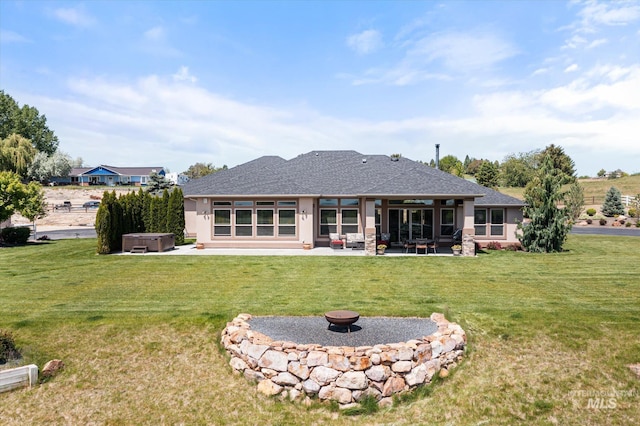550 W Heikes Ln, Eagle, ID 83616 - rear view of property featuring a hot tub, a fire pit, a patio, a lawn, and stucco siding