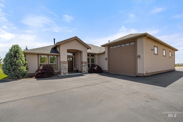 550 W Heikes Ln, Eagle, ID 83616 - view of front facade featuring stucco siding, roof with shingles, and driveway
