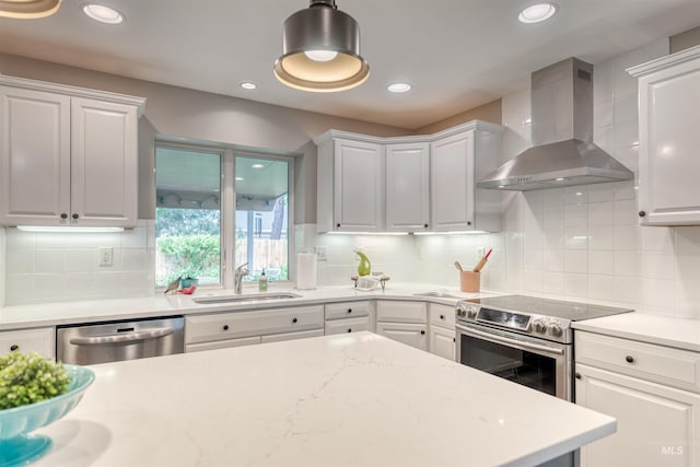 6174 W Winstead Pl, Boise, ID 83704 - kitchen with a sink, wall chimney exhaust hood, stainless steel appliances, white cabinetry, and recessed lighting