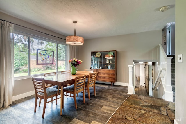 6174 W Winstead Pl, Boise, ID 83704 - dining area with dark wood-style floors, baseboards, and stairway