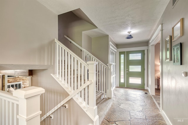 6174 W Winstead Pl, Boise, ID 83704 - entrance foyer with stone tile floors, baseboards, and a textured ceiling