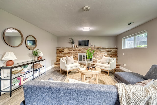6174 W Winstead Pl, Boise, ID 83704 - living room with a fireplace, baseboards, and light wood-type flooring