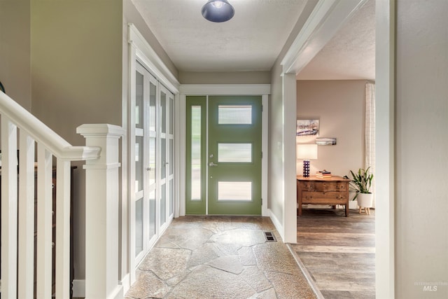 6174 W Winstead Pl, Boise, ID 83704 - entrance foyer with a textured ceiling, light wood finished floors, and stairs