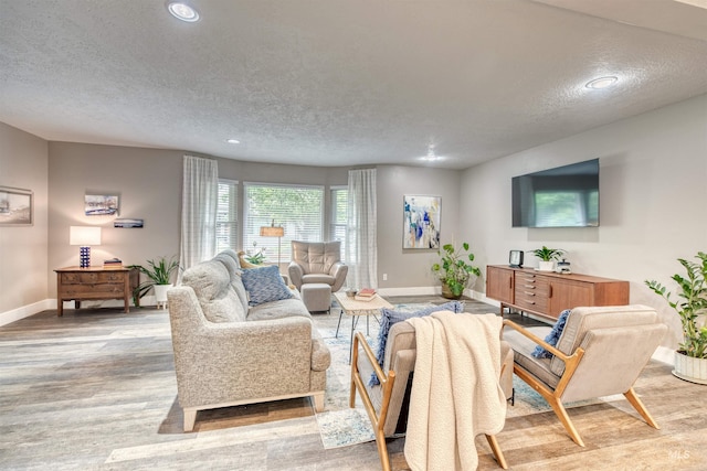 6174 W Winstead Pl, Boise, ID 83704 - living area featuring baseboards, a textured ceiling, recessed lighting, and light wood finished floors