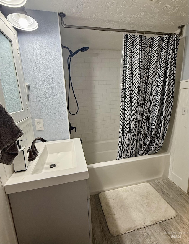 bathroom featuring hardwood / wood-style floors, shower / bath combo, and vanity