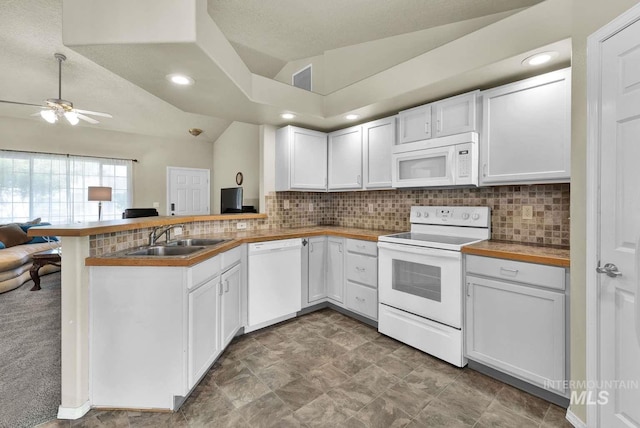 11793 Shelburne, Caldwell, ID 83605 - kitchen with a sink, a ceiling fan, backsplash, a peninsula, and white appliances