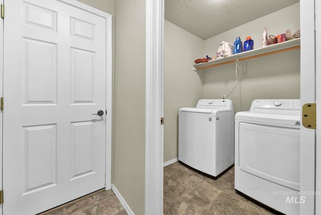 11793 Shelburne, Caldwell, ID 83605 - laundry area with a textured ceiling, baseboards, laundry area, and washer and clothes dryer
