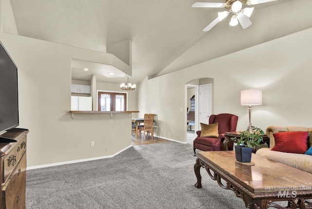 11793 Shelburne, Caldwell, ID 83605 - carpeted living area featuring arched walkways, baseboards, vaulted ceiling, and ceiling fan with notable chandelier