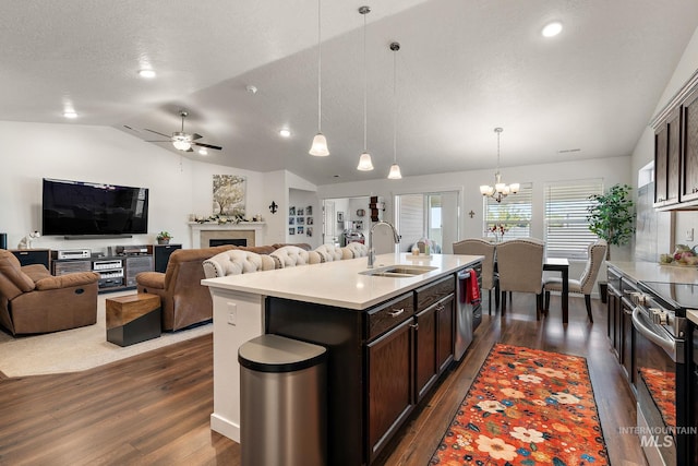 2701 N Ice Fire Pl, Star, ID 83669 - kitchen featuring a sink, appliances with stainless steel finishes, dark wood finished floors, vaulted ceiling, and a chandelier
