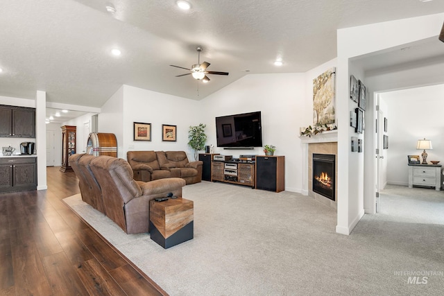 2701 N Ice Fire Pl, Star, ID 83669 - living room with a tiled fireplace, a ceiling fan, lofted ceiling, baseboards, and wood finished floors