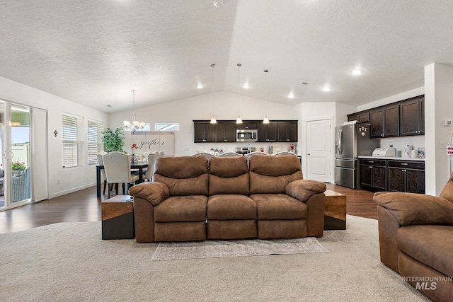 2701 N Ice Fire Pl, Star, ID 83669 - living room featuring vaulted ceiling, wood finished floors, a chandelier, a textured ceiling, and bar