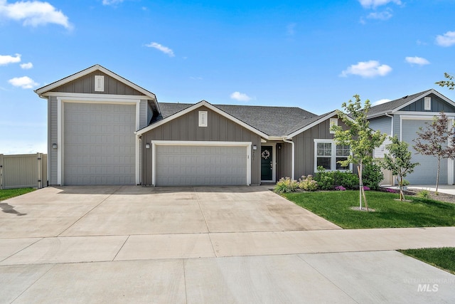 2701 N Ice Fire Pl, Star, ID 83669 - view of front of property featuring a garage, driveway, a front yard, board and batten siding, and a gate
