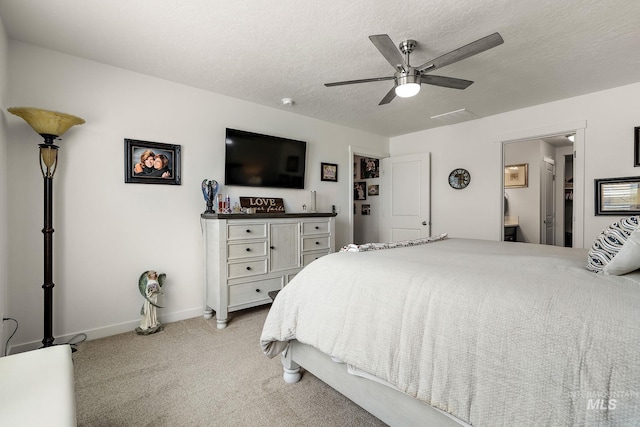 2701 N Ice Fire Pl, Star, ID 83669 - bedroom with light colored carpet, baseboards, a textured ceiling, a ceiling fan, and connected bathroom