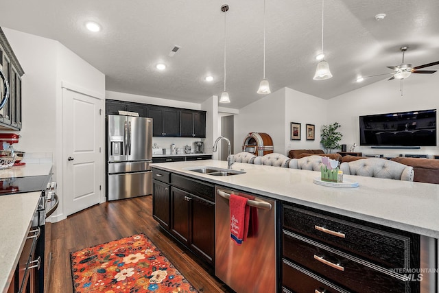 2701 N Ice Fire Pl, Star, ID 83669 - kitchen featuring appliances with stainless steel finishes, a sink, open floor plan, dark wood finished floors, and ceiling fan