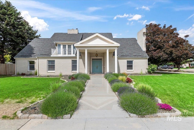 905 S Canyon St, Nampa, ID 83686 - greek revival house featuring a chimney, a balcony, and brick siding