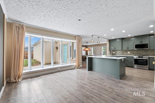 905 S Canyon St, Nampa, ID 83686 - kitchen featuring appliances with stainless steel finishes, light countertops, recessed lighting, backsplash, and a textured ceiling