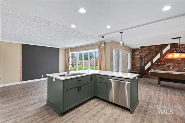 905 S Canyon St, Nampa, ID 83686 - kitchen featuring dishwasher, a sink, light wood-style flooring, light countertops, and brick wall