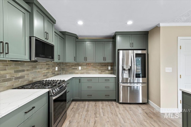 905 S Canyon St, Nampa, ID 83686 - kitchen featuring appliances with stainless steel finishes, light wood finished floors, decorative backsplash, ornamental molding, and baseboards
