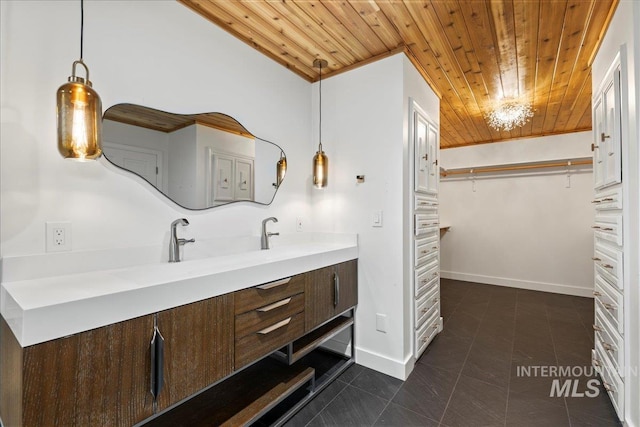905 S Canyon St, Nampa, ID 83686 - bathroom with wood ceiling, vanity, tile patterned flooring, a spacious closet, and baseboards