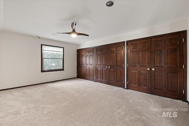 905 S Canyon St, Nampa, ID 83686 - unfurnished bedroom featuring light colored carpet, baseboards, multiple closets, and ceiling fan