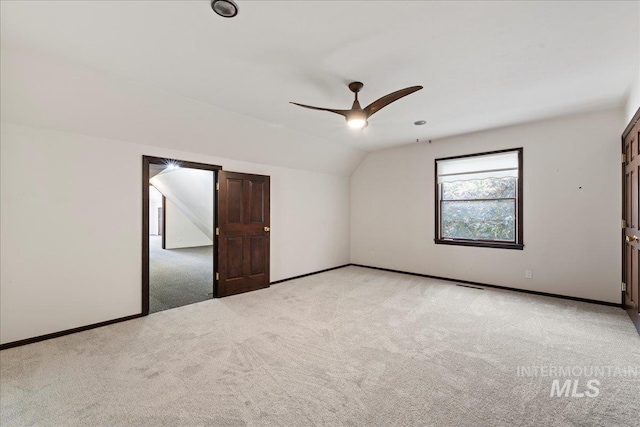 905 S Canyon St, Nampa, ID 83686 - spare room featuring light colored carpet, vaulted ceiling, ceiling fan, and baseboards