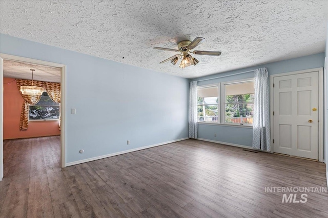 905 S Canyon St, Nampa, ID 83686 - empty room featuring a textured ceiling, a ceiling fan, wood finished floors, and baseboards