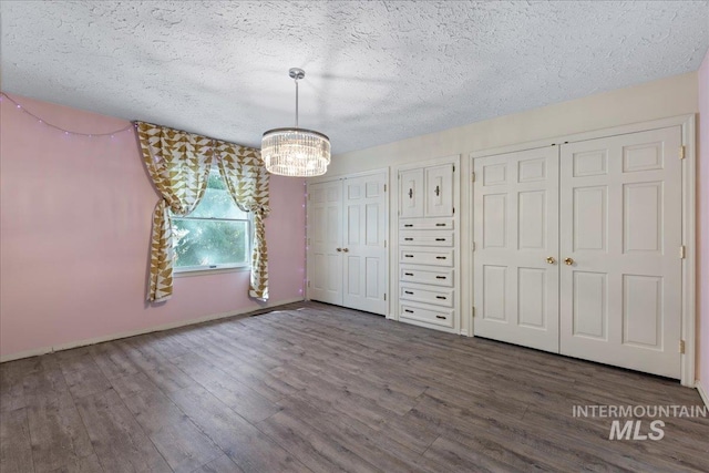 905 S Canyon St, Nampa, ID 83686 - unfurnished dining area with a chandelier, wood finished floors, a textured ceiling, and baseboards