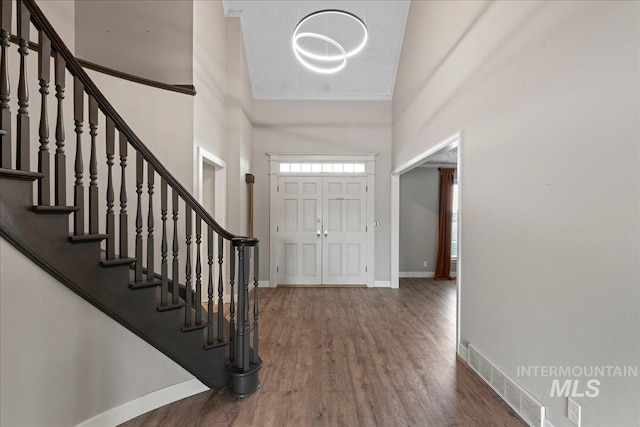 905 S Canyon St, Nampa, ID 83686 - entryway with stairs, crown molding, wood finished floors, and baseboards