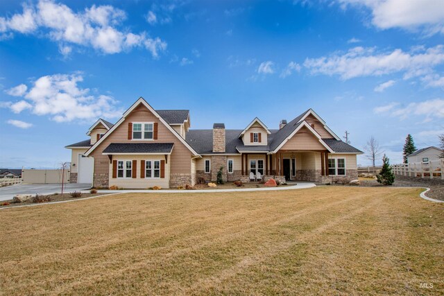 14050 Hidalgo Ranch Pl, Nampa, ID 83651 - craftsman house featuring a chimney, fence, a front lawn, a shingled roof, and stone siding