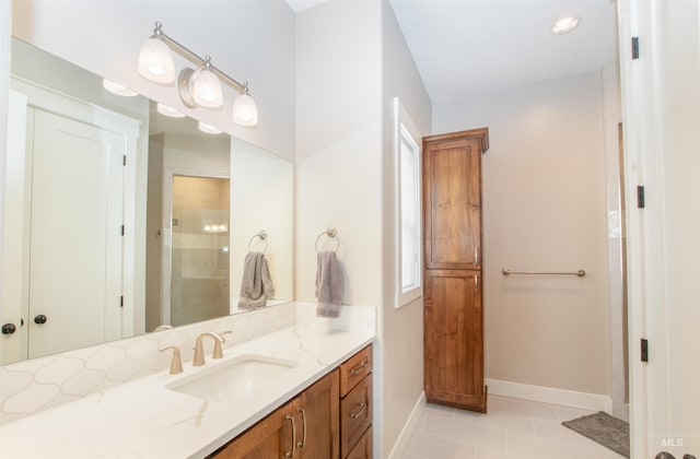 14050 Hidalgo Ranch Pl, Nampa, ID 83651 - bathroom featuring walk in shower, baseboards, vanity, and tile patterned floors