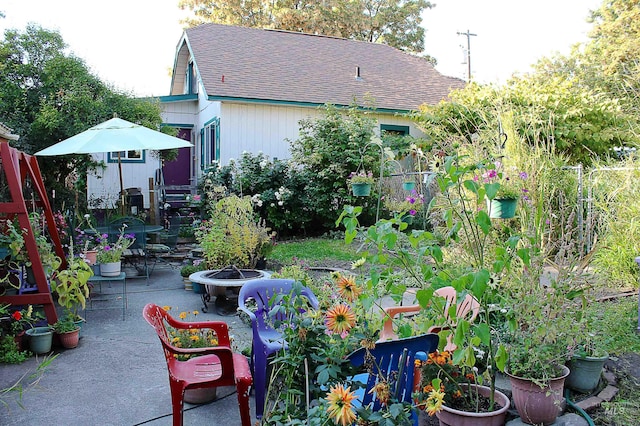 view of yard featuring a patio area and a fire pit