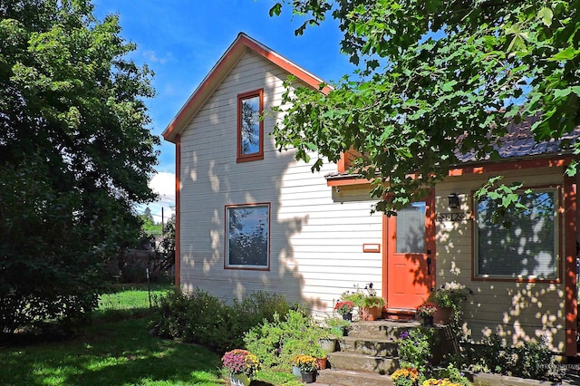 rear view of property with a yard