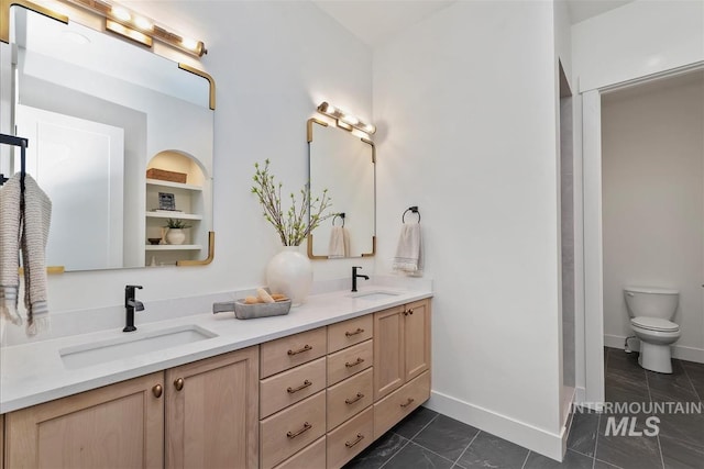 938 S Waning Ln, Eagle, ID 83616 - bathroom featuring double vanity, toilet, baseboards, and tile patterned flooring