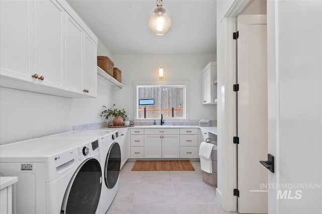 938 S Waning Ln, Eagle, ID 83616 - washroom featuring washer and dryer, cabinet space, and light tile patterned floors