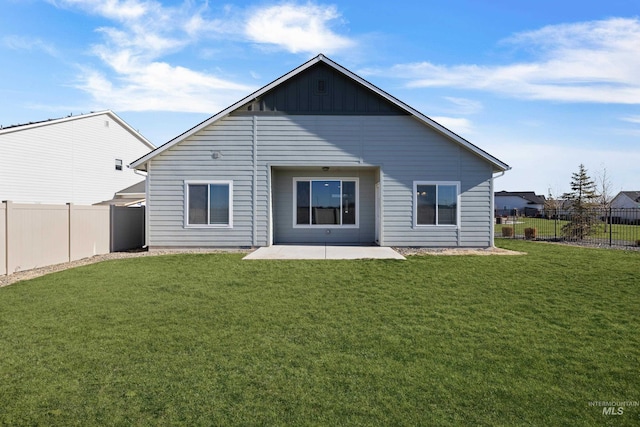 back of property featuring a patio area, a fenced backyard, board and batten siding, and a yard