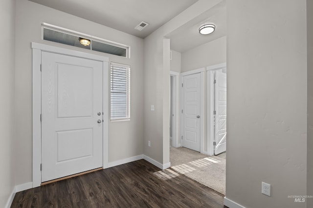 entryway featuring baseboards, visible vents, and dark wood-style flooring