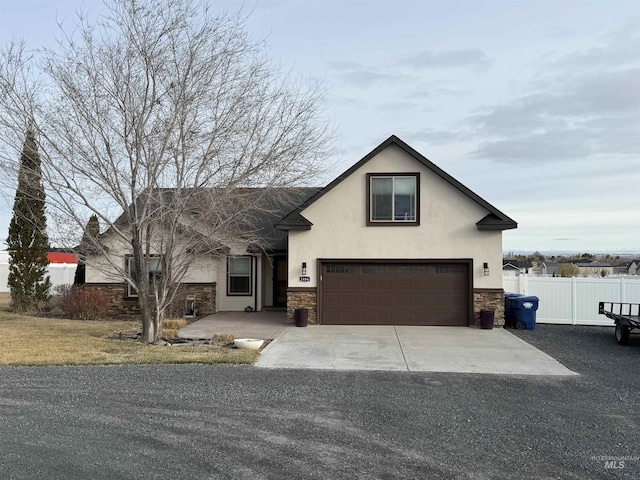 2486 E 3745, Twin Falls, ID 83301 - view of front of property featuring an attached garage, stucco siding, stone siding, and fence