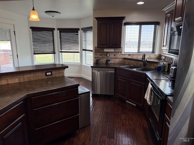 2486 E 3745, Twin Falls, ID 83301 - kitchen featuring dark countertops, a wealth of natural light, dark wood-type flooring, a sink, and black appliances