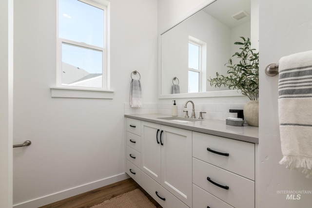 bathroom with vanity and hardwood / wood-style flooring