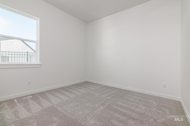 empty room featuring light carpet