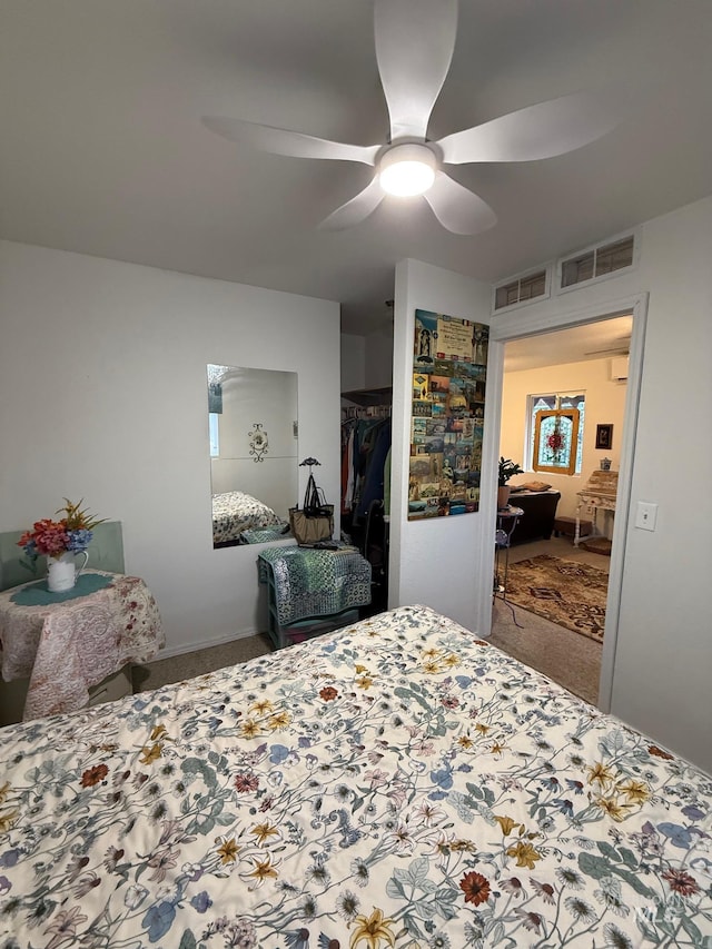 bedroom with ceiling fan, carpet floors, and a closet