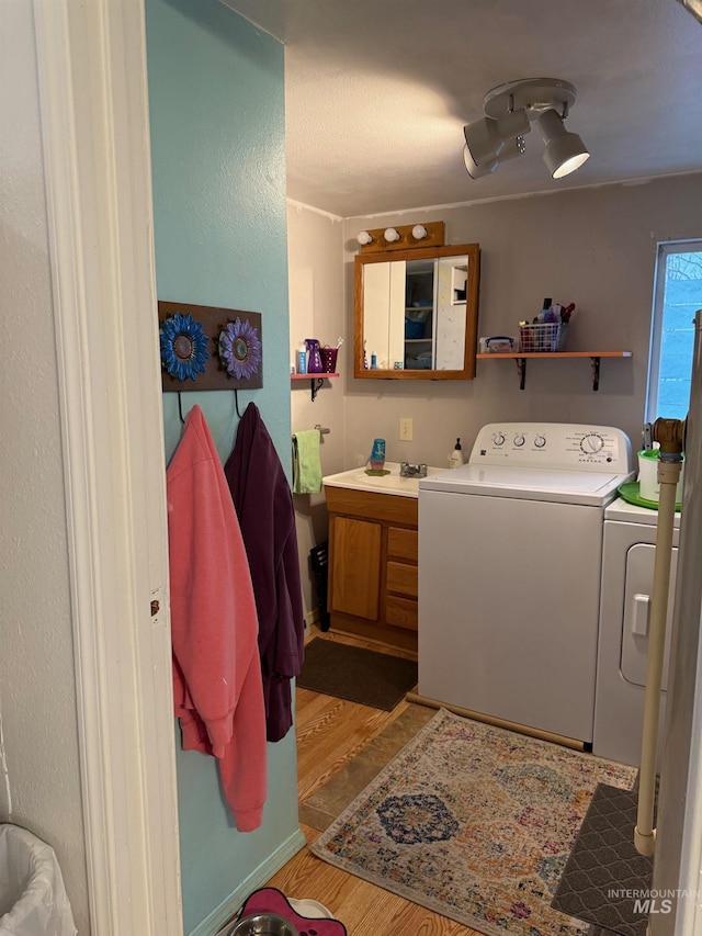 bathroom featuring vanity, hardwood / wood-style flooring, and washing machine and dryer