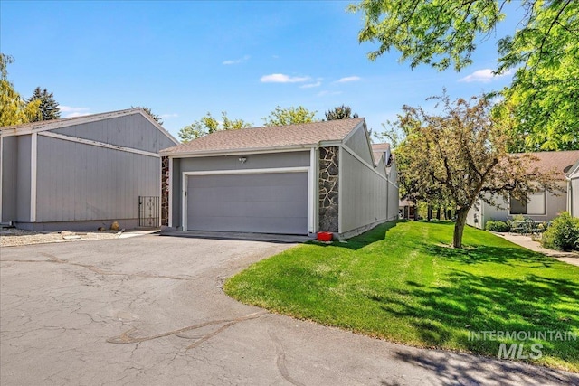 300 Morrison Unit 643, Twin Falls, ID 83301 - view of front of house with asphalt driveway, a front lawn, and an attached garage