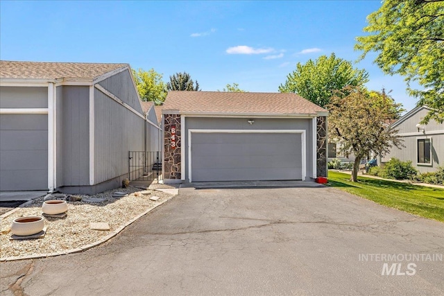 300 Morrison Unit 643, Twin Falls, ID 83301 - view of front of house with a garage, driveway, and stone siding