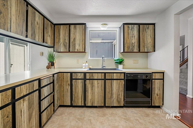 300 Morrison Unit 643, Twin Falls, ID 83301 - kitchen featuring black dishwasher, a sink, light countertops, and a textured ceiling