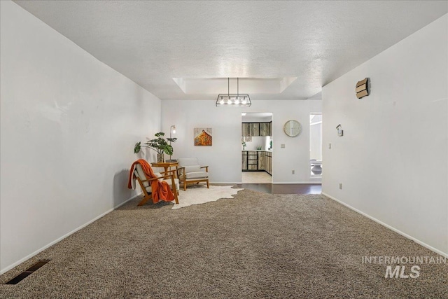 300 Morrison Unit 643, Twin Falls, ID 83301 - sitting room with carpet floors, a raised ceiling, baseboards, and a textured ceiling